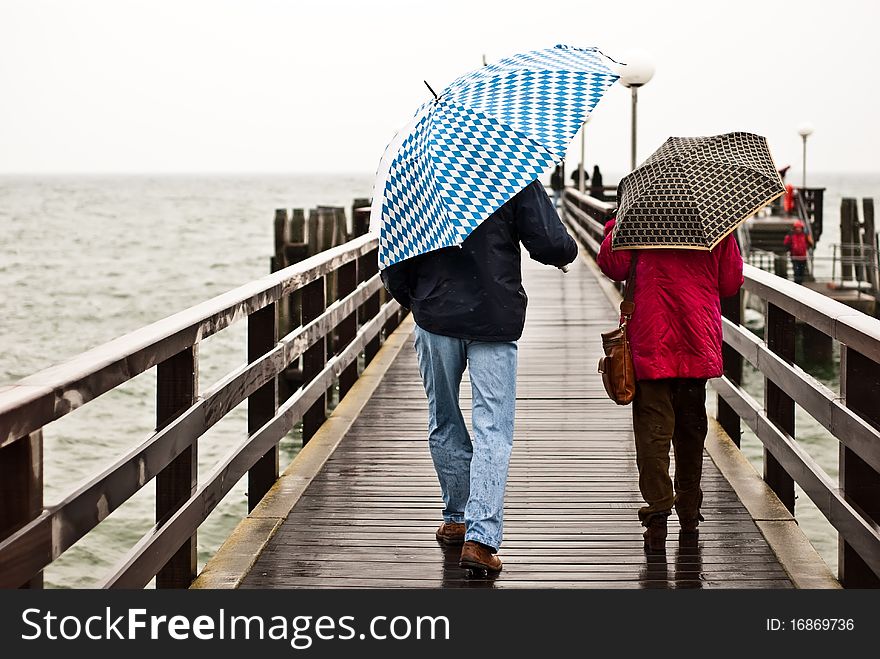 With Umbrella On The Pier