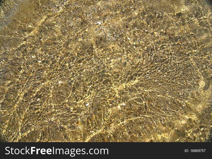 Beautiful clear sea water with seashells on bottom reflecting in the sun. Beautiful clear sea water with seashells on bottom reflecting in the sun