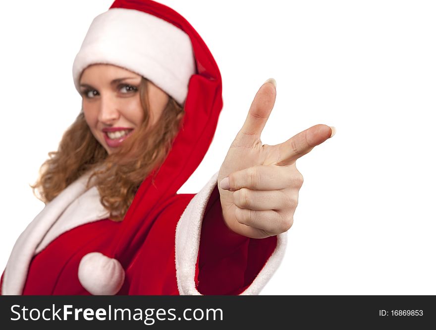 Dancing girl in santa suit is pointing her finger at the camera and looking with a smile. Isolated on white.