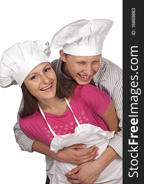 Young loving couple cooks. Over white background