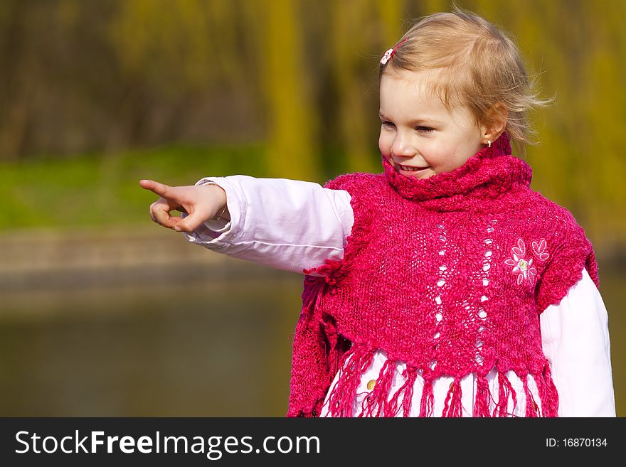 Four year old girl pointing on something in park. Four year old girl pointing on something in park.