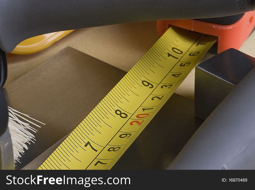 Tape measure in between a set of worker's tools.