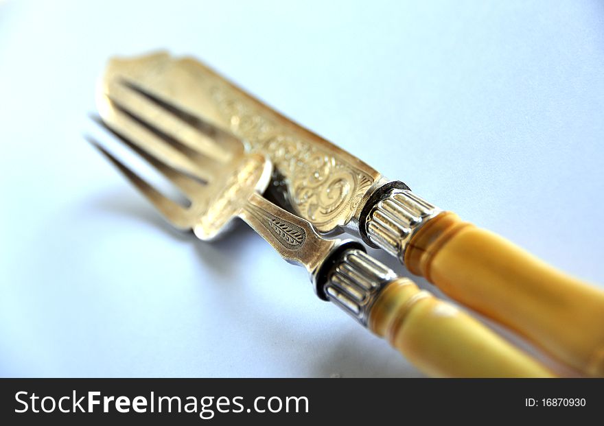 Luxury cutlery, with ivory handle and work over white background. Luxury cutlery, with ivory handle and work over white background