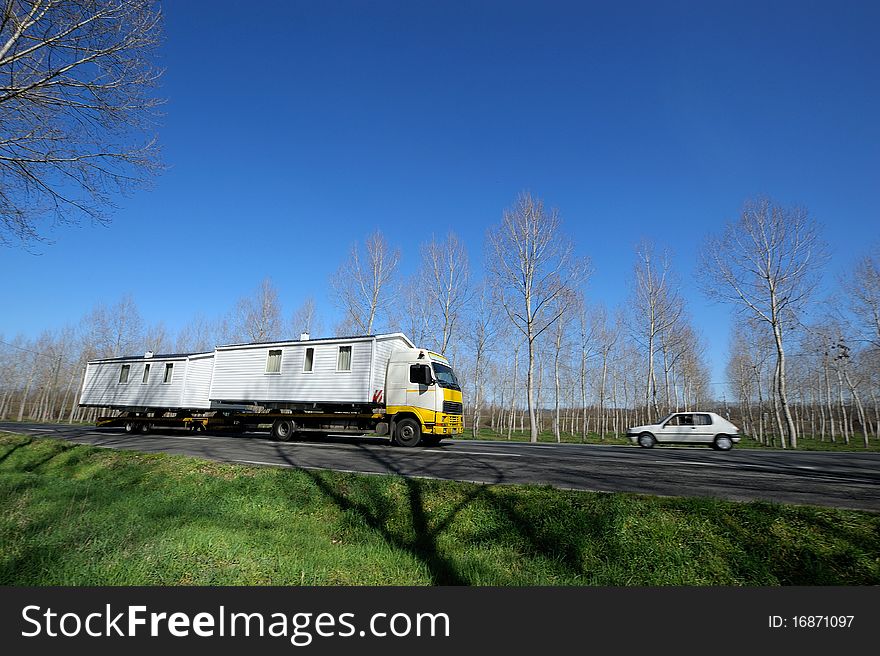 Transporting prefabricated house by the road. Transporting prefabricated house by the road