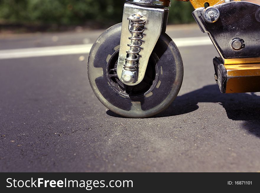 Close-up scooter wheel on the pavement ready to drive