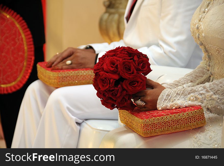 Bouquet of red roses in the hands of newly married couple. Bouquet of red roses in the hands of newly married couple