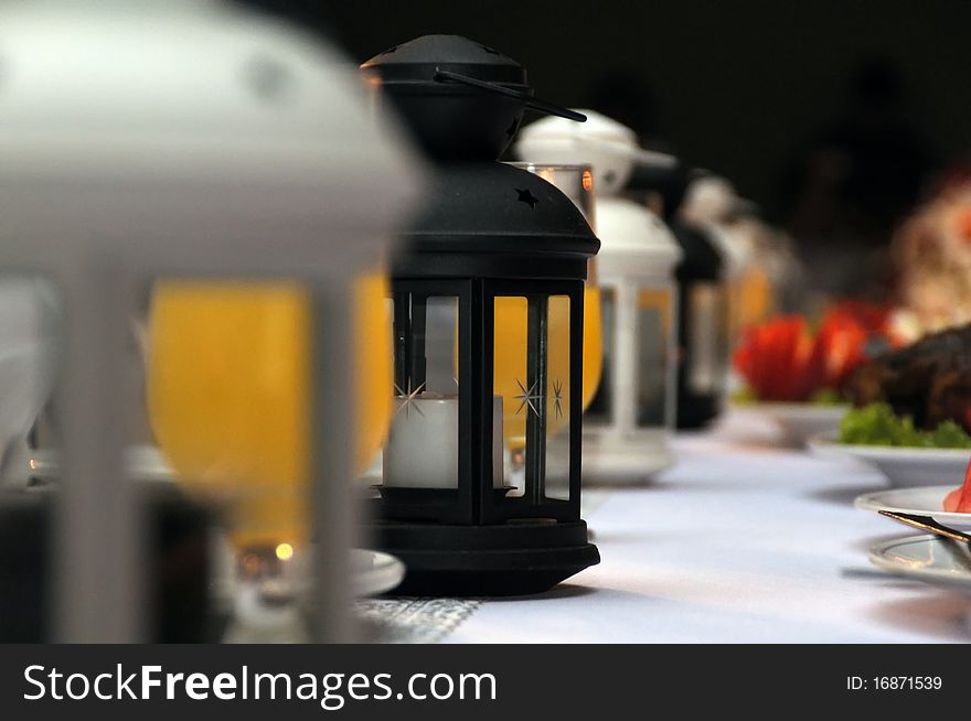 A lantern style candle holder lineup on table