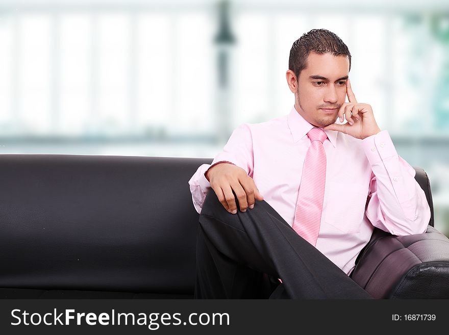 Businessman thinking on a sofa, indoor image