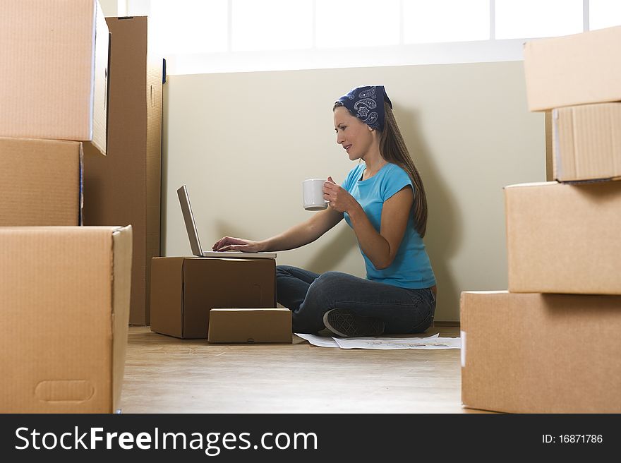 Woman with laptop in new home