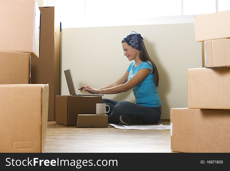 Woman with laptop in new home