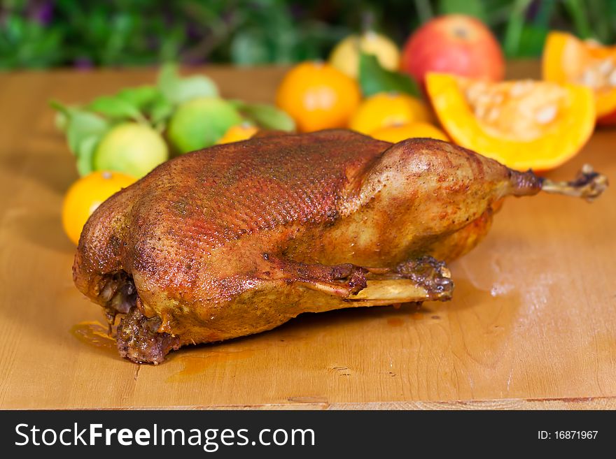 Fresh and Baked Goose with decoration of fruits .