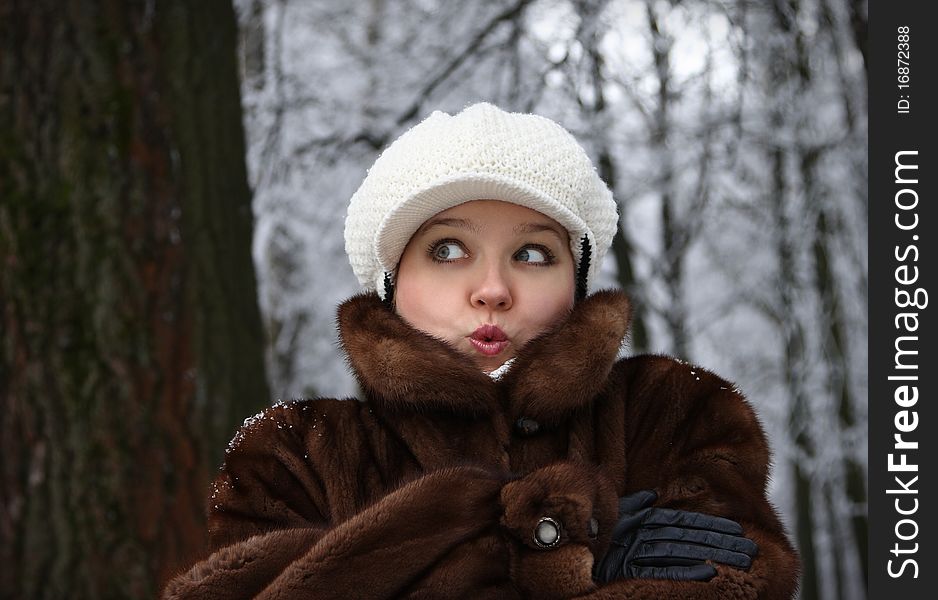 The surprised girl in a fur coat