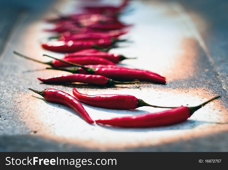 Many red peppers are in a bowl. Many red peppers are in a bowl