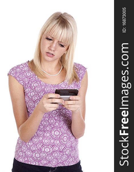 A woman confused at a text she is receiving on her cell phone. A woman confused at a text she is receiving on her cell phone.