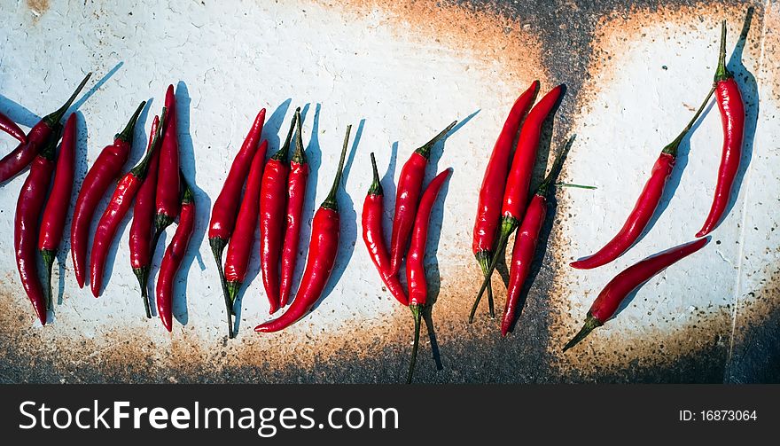 Many red peppers are in a bowl. Many red peppers are in a bowl