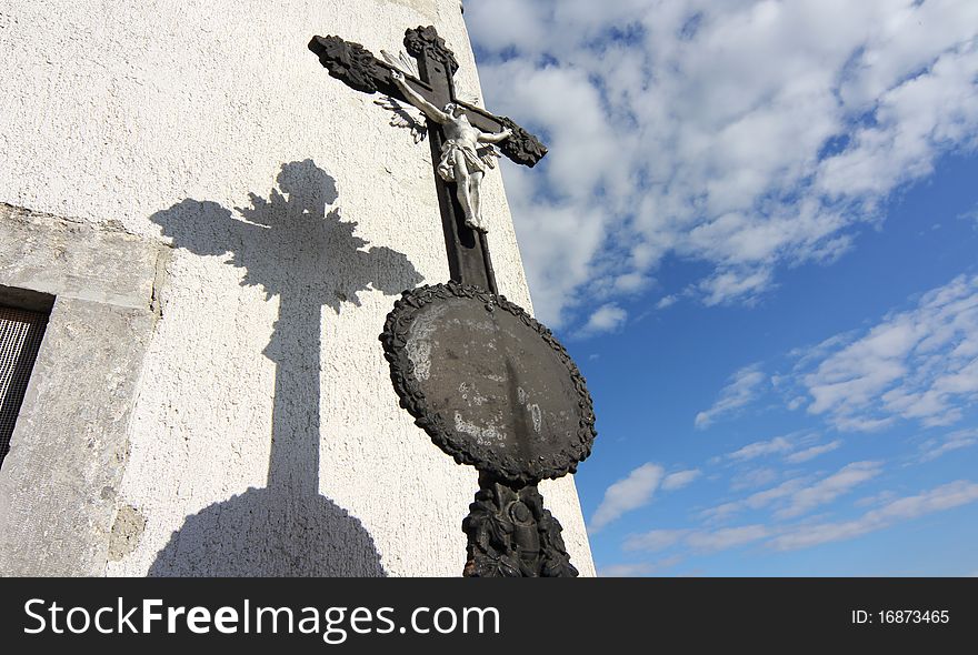 Old metal roman church cross with shadow. Old metal roman church cross with shadow
