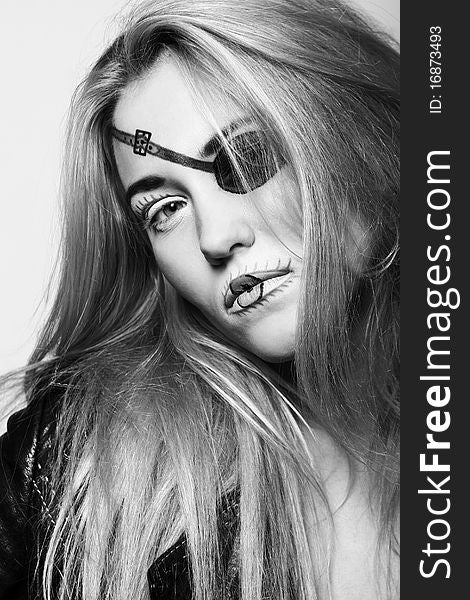 Attractive and beautiful blonde in black with abstract pirate make-up. Attractive and beautiful blonde in black with abstract pirate make-up