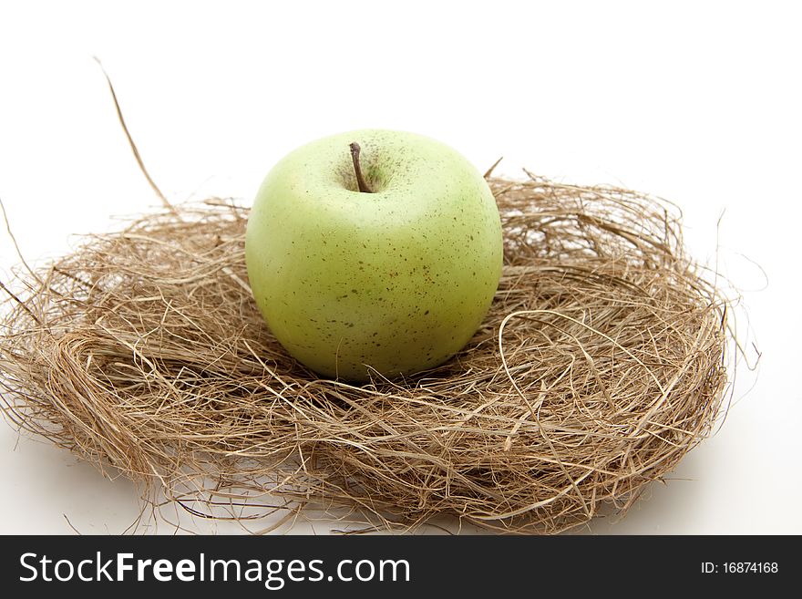 Green apple in the dried grass. Green apple in the dried grass