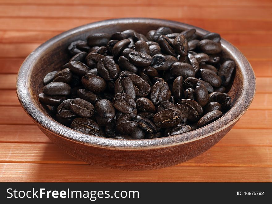 Coffee beans in a wooden bowl