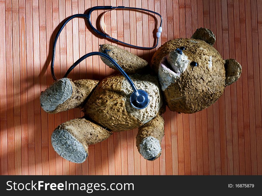 Old teddy bear with a stethoscope