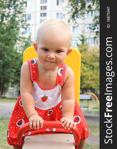 Cute little girl swinging in the  playground