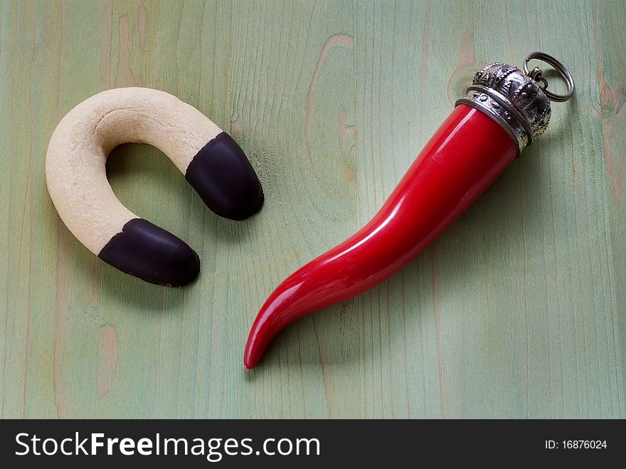 Chocolate biscuit in the shape of a horseshoe and a red horn. Chocolate biscuit in the shape of a horseshoe and a red horn