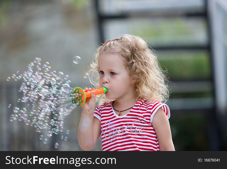 Young girl blowing bubbles.