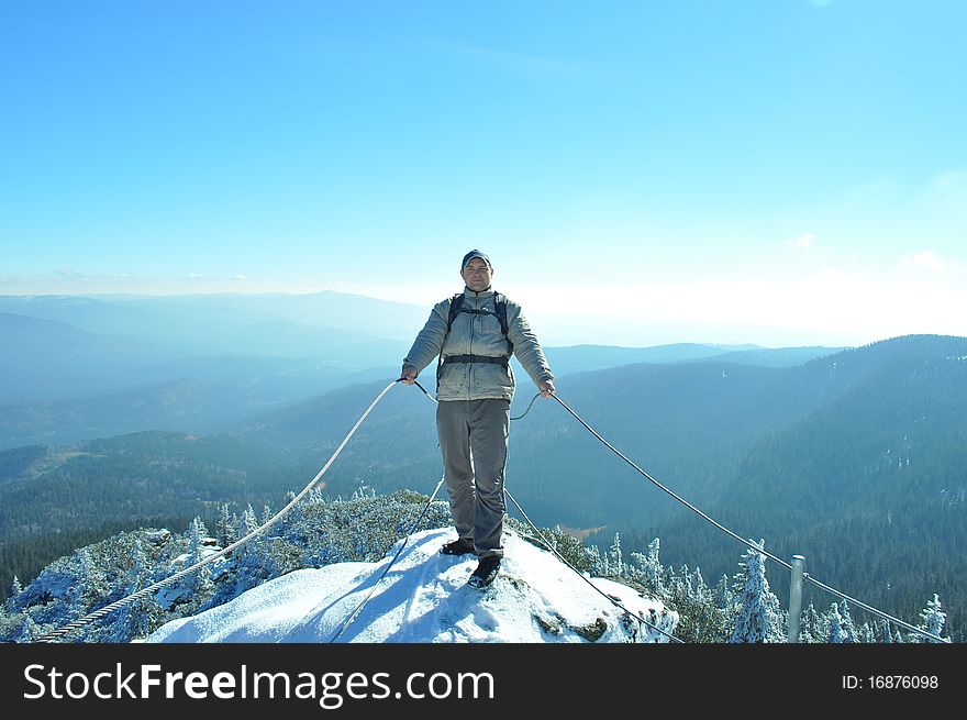 Tourist in mountains on winter day