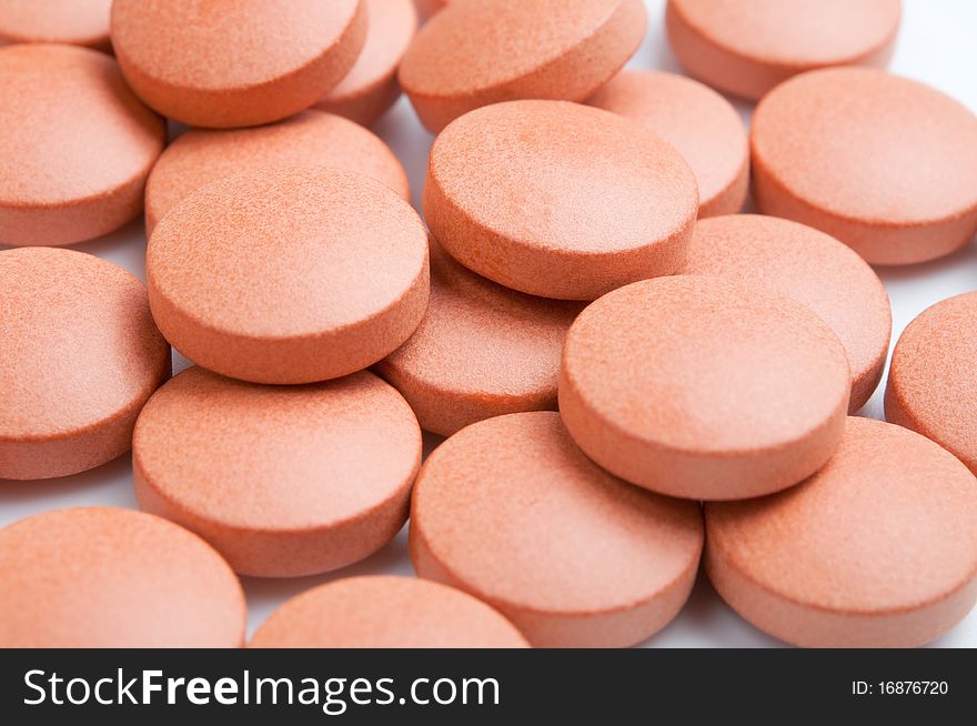 Close-up of many orange pills, selective focus. Close-up of many orange pills, selective focus.