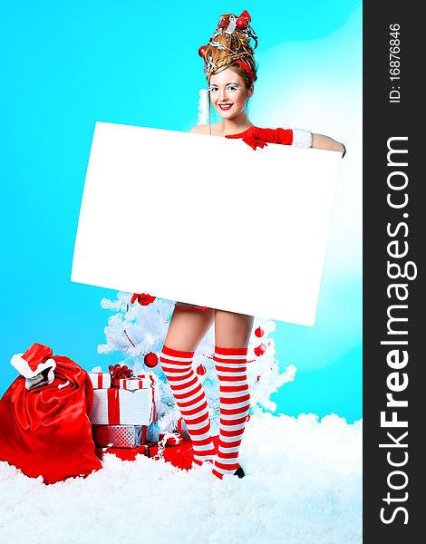 Beautiful young woman in Santa Claus clothes over Christmas background. Beautiful young woman in Santa Claus clothes over Christmas background.