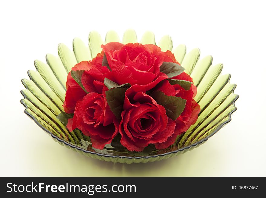 Bunch of roses in green glass bowl