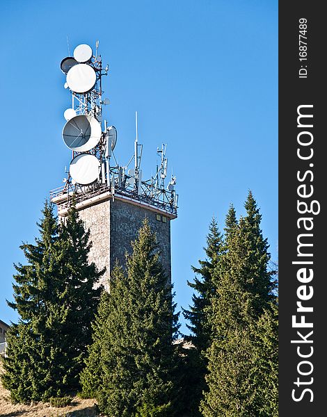 Telecommunications tower with many satellite dish placed in the mountains. Telecommunications tower with many satellite dish placed in the mountains