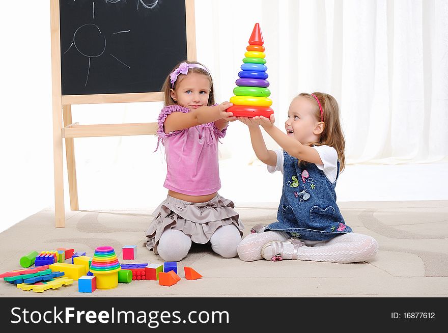 Two little girls play with friends and have fun