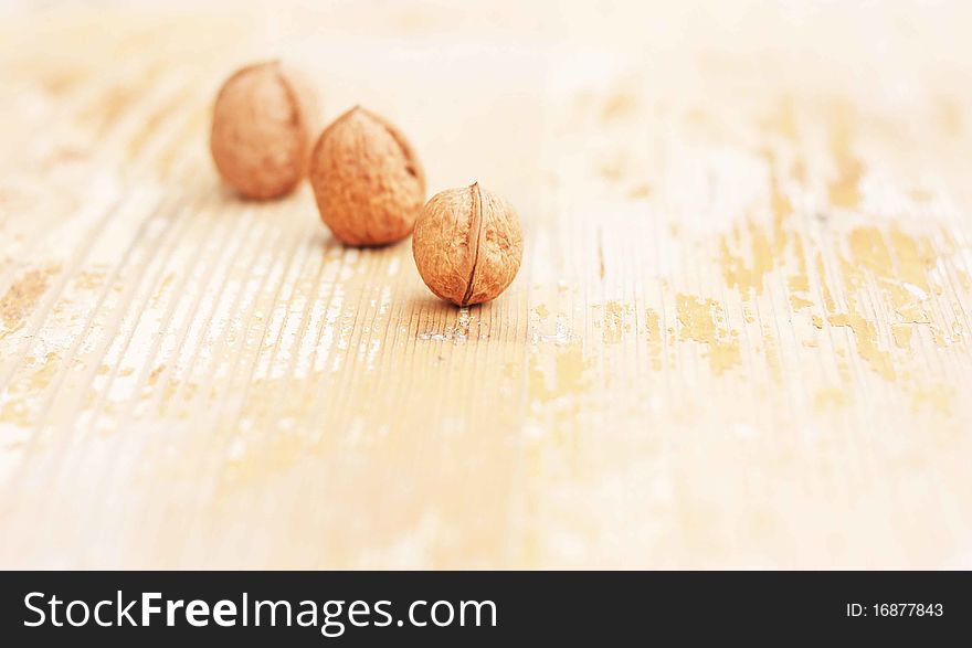Walnuts three consecutive on natural wood background for use in the manufacture of natural wood doors