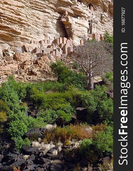 Vertical image of ancient traditional buildings along the Bandiagara escarpment in Dogon country in Mali. Vertical image of ancient traditional buildings along the Bandiagara escarpment in Dogon country in Mali