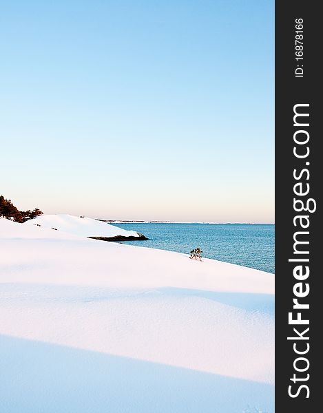 Coastal view with snow covered land. Coastal view with snow covered land