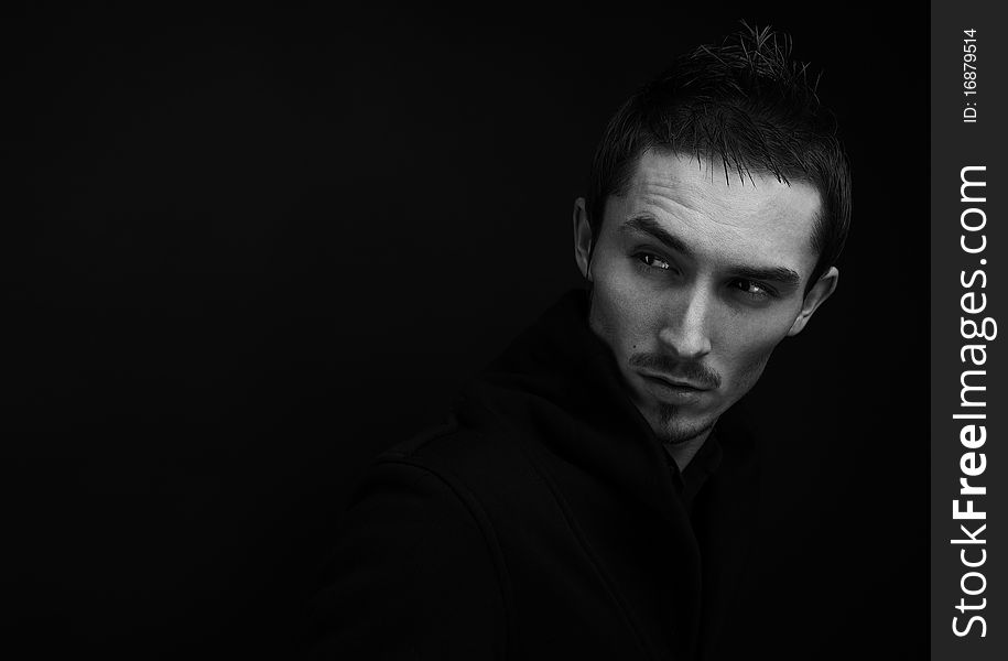 Attractive young man wearing elegant black suit