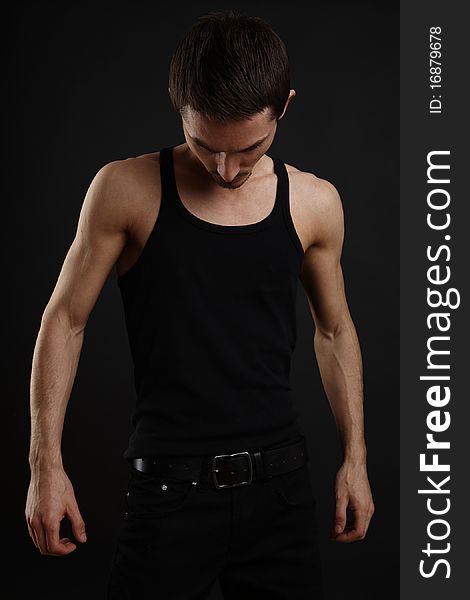 Muscular young fashion man with strong arms.