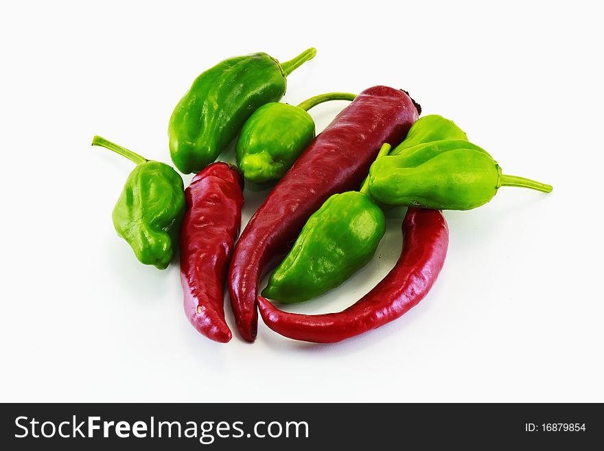 Red and green peppers in white