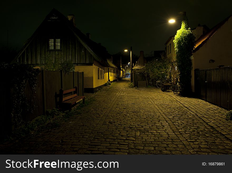 A village at night with a high tech blue center