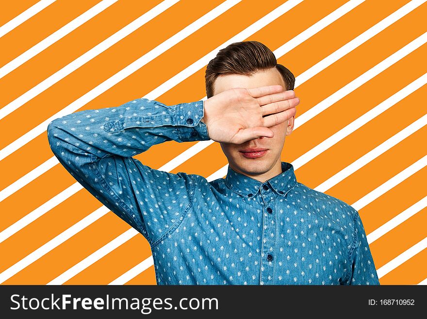 Portrait of upset man covering his face with hand