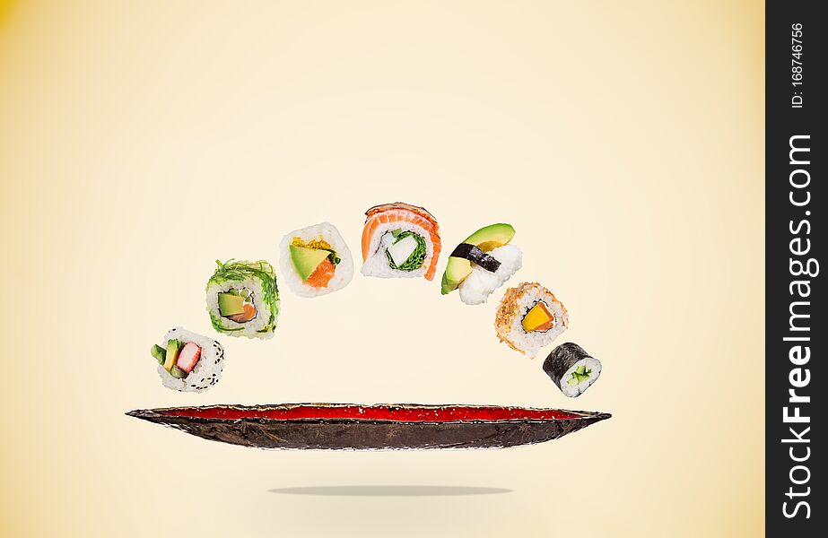 Pieces of delicious japanese sushi frozen in the air on pastel color background. Pieces of delicious japanese sushi frozen in the air on pastel color background.