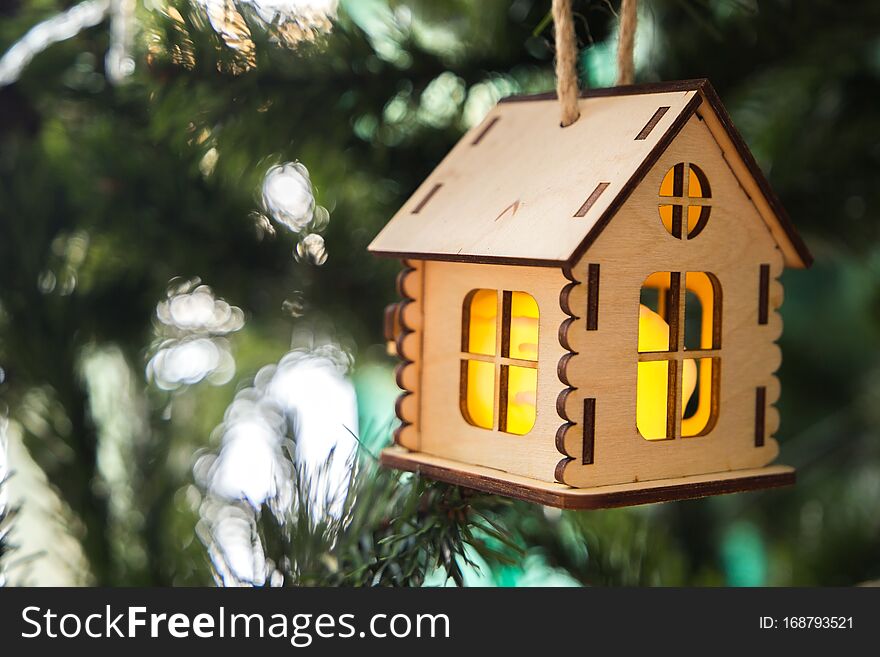 Christmas toy house in bright green moss and fir branches