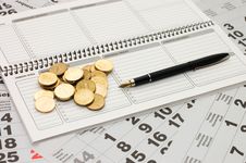 Sheets Of A Calendar With Coins And A Notebook Stock Photo Sheets Of A Calendar With Coins And A Notebook Stock Photo