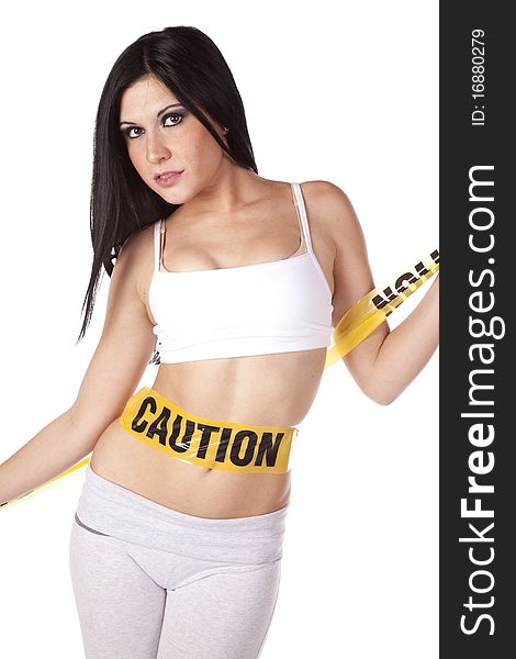 A woman has caution taped wrapped around her slender belly. A woman has caution taped wrapped around her slender belly.