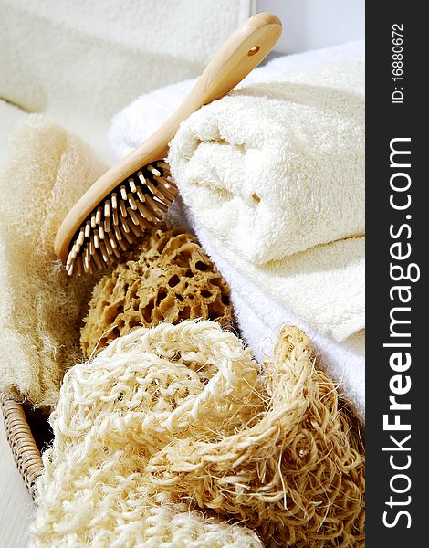 Close up shot of the towel, brush and sea sponge placed in a basket. Close up shot of the towel, brush and sea sponge placed in a basket