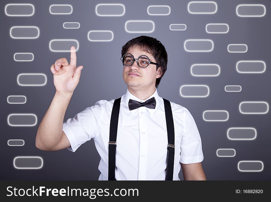 Portrait of funny fashion men in suspender with bow tie and glasses show visual plate. Studio shot. Portrait of funny fashion men in suspender with bow tie and glasses show visual plate. Studio shot.