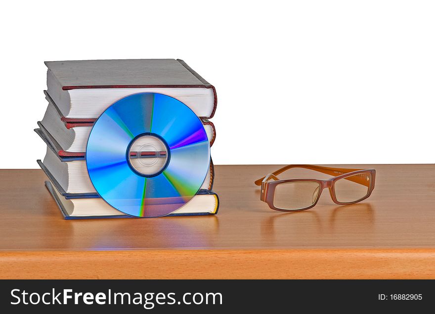 Books, eyeglasses, and DVD on desk