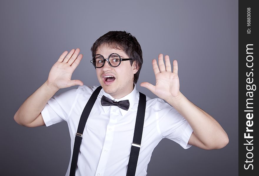 Portrait of funny fashion men in suspender with bow tie and glasses. Studio shot.