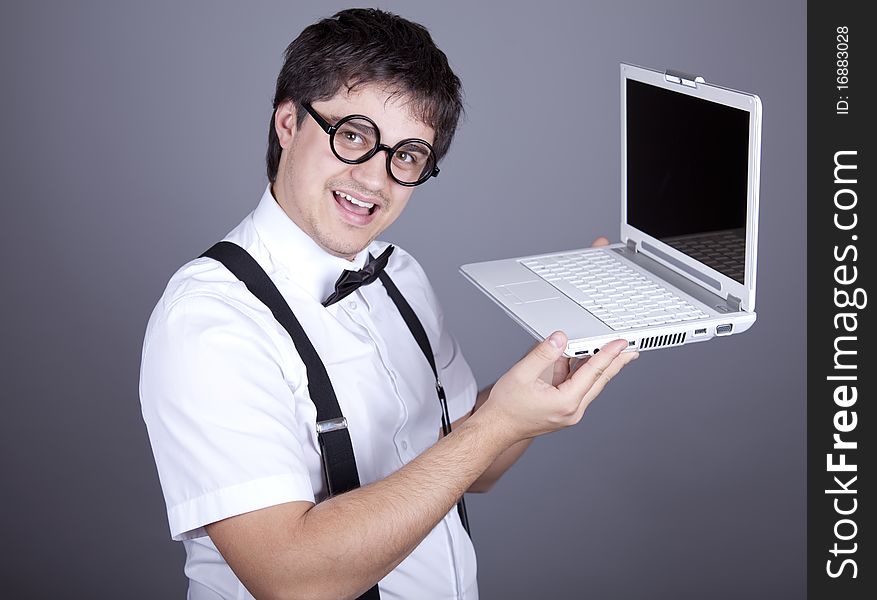 Portrait of funny fashion men in suspender with bow tie and glasses keeping notebook. Studio shot. Portrait of funny fashion men in suspender with bow tie and glasses keeping notebook. Studio shot.